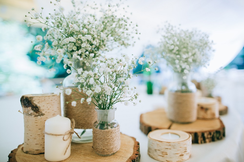 Naturbelassene Hochzeitsdeko mit Blumen und Holz